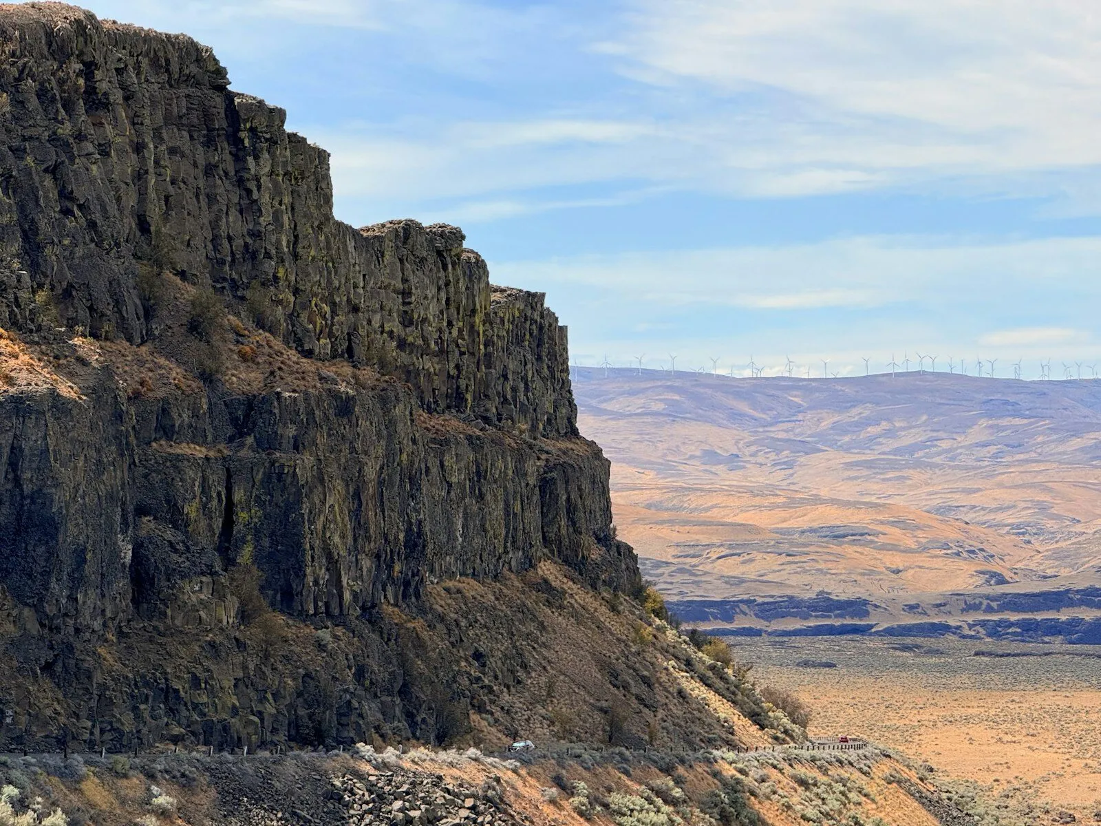 Basalt cliffs of Frenchman Coulee near Quincy, Washington, with wind turbines on the far ridge