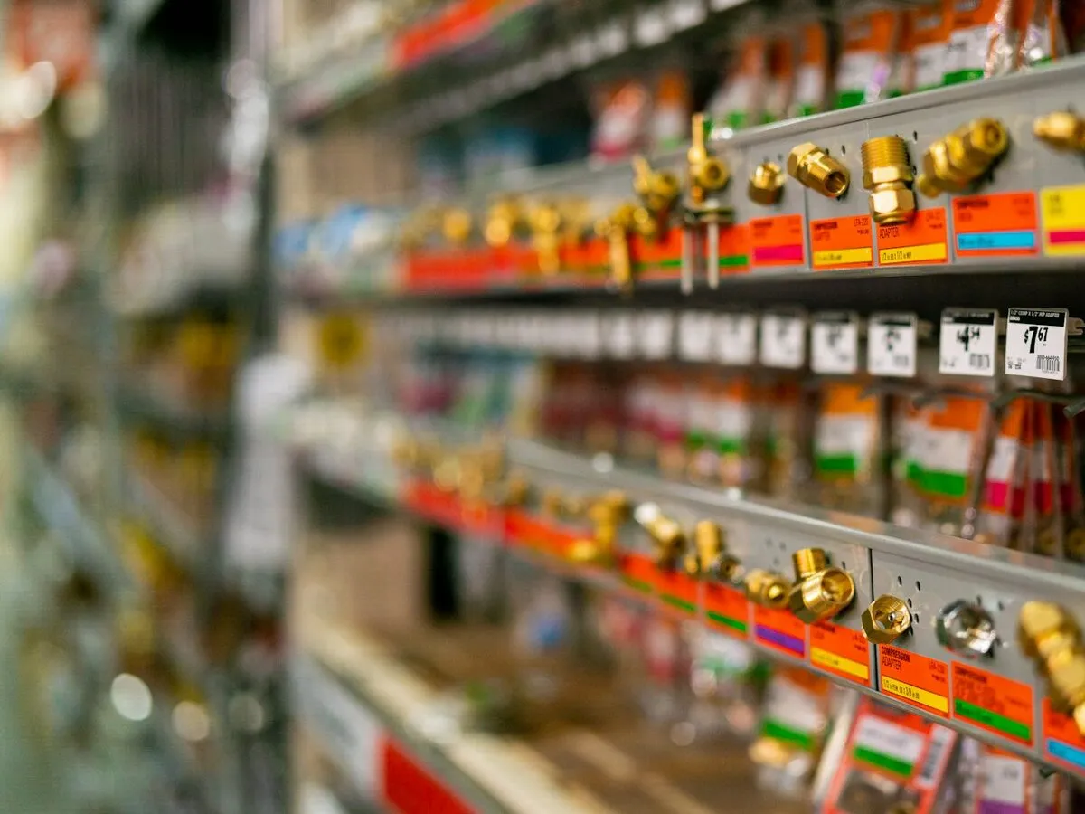 Hardware store shelves of brass fittings with price tags